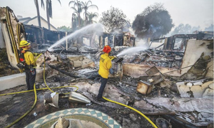 INTERNATIONAL NEWS: Fast-growing wildfire destroys homes in California